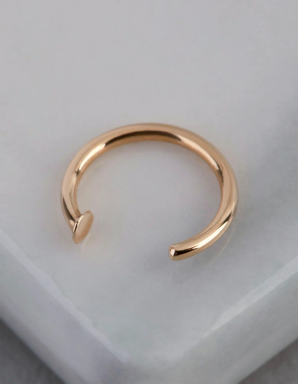 1627-9ct-gold-mini-nail-open-nose-ring-1.webp 9ct Gold Mini Nail Open Nose Ring