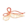 500-gold-red-bow-claw-clip-1.webp Gold Red Bow Claw Clip