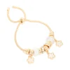 527-gold-white-flower-charm-trio-toggle-bracelet-2.webp Gold White Flower Charm Trio Toggle Bracelet