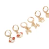 532-kids-gold-dog-paw-huggie-earrings-4-pack-2.webp Kids Gold Dog & Paw Huggie Earrings 4-Pack